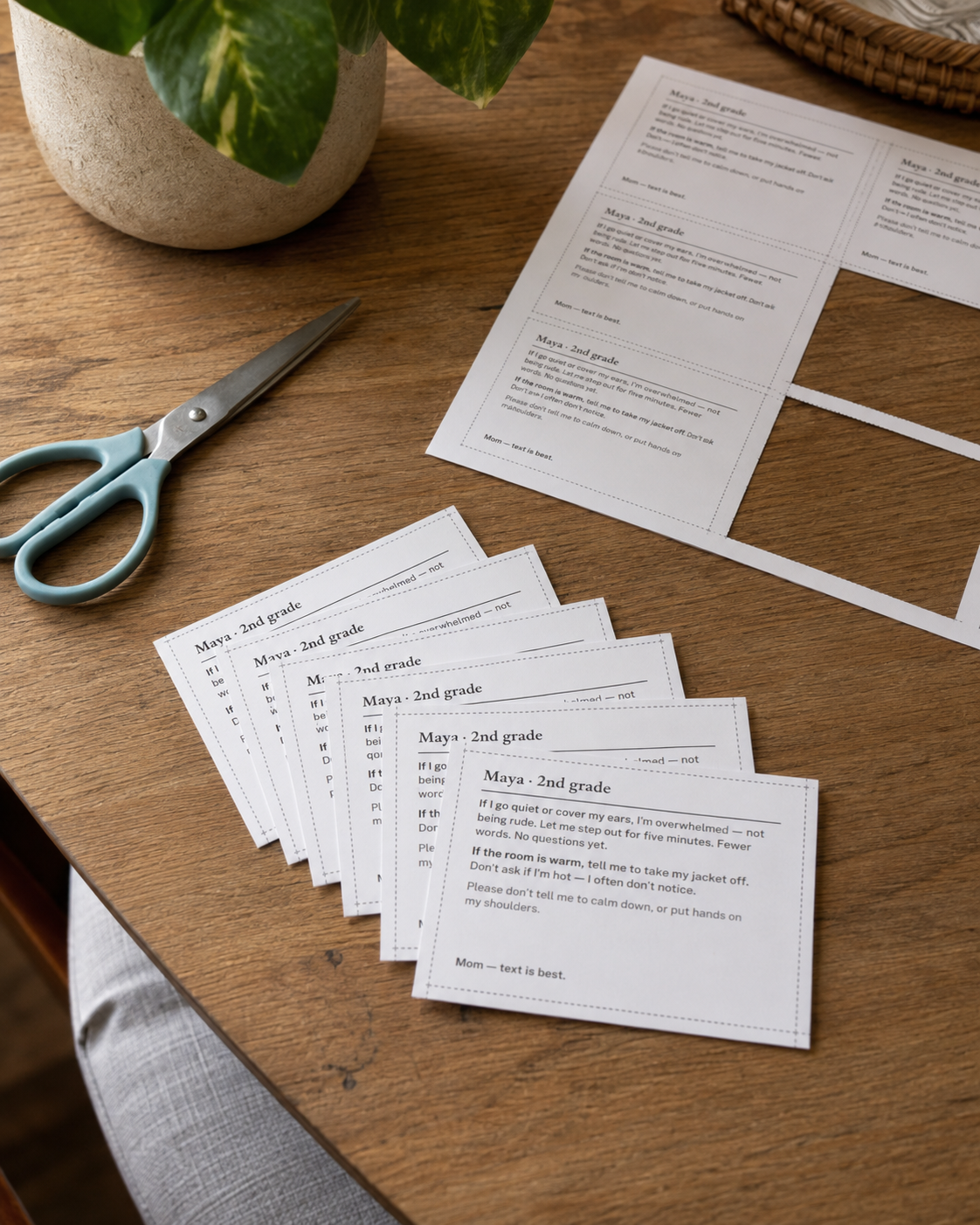 Eight cut-out carry cards beside the sheet they were printed on.
